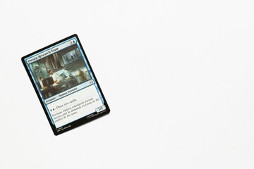 Obraz premium Bradford, UK Nov 3 2025 Oscorp Research Team card from the Spider-man magic the gathering card game shot isolated on a white paper background.