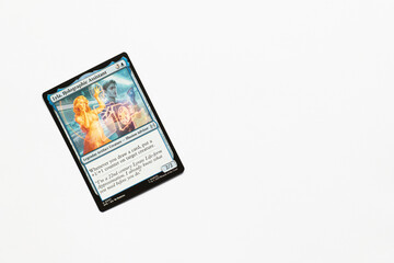 Obraz premium Bradford, UK Nov 3 2025 Lyla, Holographic Assistant card from the Spider-man magic the gathering card shot isolated on a white paper background.