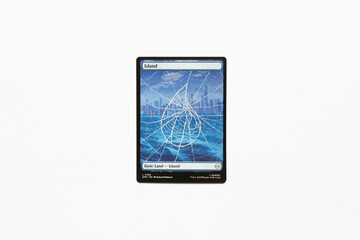 Naklejka premium Bradford, UK Nov 3 2025 Basic Land Island card from the Spider-man magic the gathering card game shot isolated on a white paper background.