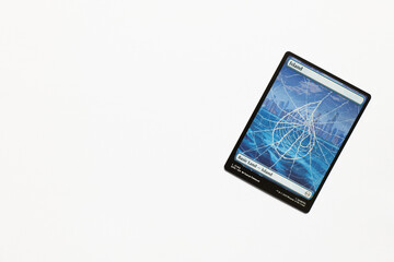 Naklejka premium Bradford, UK Nov 3 2025 Basic Land Island card from the Spider-man magic the gathering card game shot isolated on a white paper background.