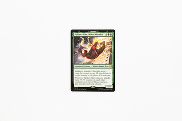 Naklejka premium Bradford, UK Nov 3 2025 Spider-man, Miles Morales card from the Spider-man magic the gathering card game shot isolated on a white paper background.