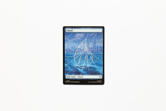 Bradford, UK Nov 3 2025 Basic Land Island card from the Spider-man magic the gathering card game shot isolated on a white paper background.