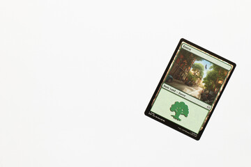 Naklejka premium Bradford, UK Nov 3 2025 Forest basic land card from Spider-man magic the gathering game shot isolated on a white paper background.