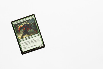 Naklejka premium Bradford, UK Nov 3 2025 Twisted Spider-clone card from Spider-man magic the gathering game shot isolated on a white paper background.