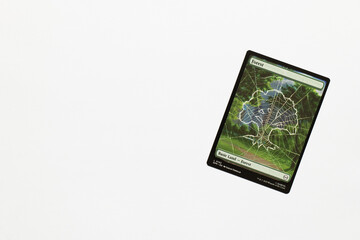 Naklejka premium Bradford, UK Nov 3 2025 Forest, basic land card from Spider-man magic the gathering card game shot isolated on a white paper background.