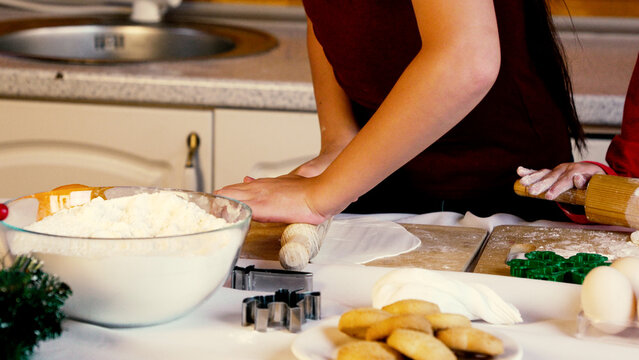 A mother with child are baking Christmas cookies