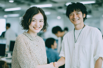Smiling coworkers interacting in a bright modern office environment