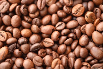 Textured background of freshly roasted coffee beans close up