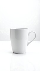 Fototapeta premium A pristine white ceramic mug stands solitary, reflecting softly on a bright white surface against a clean, minimalist background