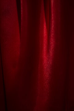 Close-up photo of a luxurious red satin background. Beautiful colors convey (blur or berry).
