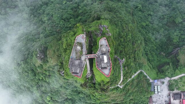 Aerial view of the majestic Fanjingshan Temple perched atop a verdant mountain, a testament to architectural wonder, Fanjingshan, Guizhou, China.