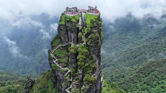 Aerial view of Fanjingshan Temple perched atop a towering rock formation with winding staircases, Fanjingshan, Guizhou, China.