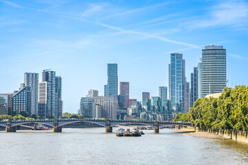 Fototapeta premium Modern skyline of London with high-rise buildings and blue sky.