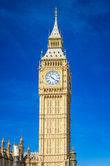 Close-up of Big Ben clock face under bright sunlight in London on a sunny day