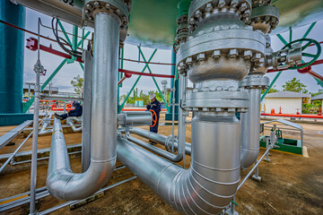 Male worker inspection at steel long pipes and pipe elbow in station oil factory during refinery valve of visual check record