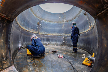 Male worker inspection vacuum test bottom plate tank petrochemical steel weld