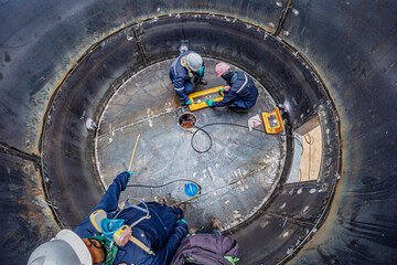 Male worker inspection vacuum test bottom plate tank petrochemical steel weld
