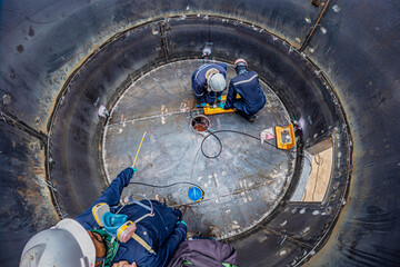 Male worker inspection vacuum test bottom plate tank petrochemical steel weld