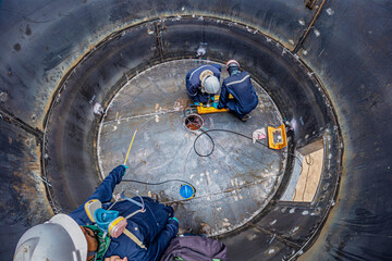 Male worker inspection vacuum test bottom plate tank petrochemical steel weld