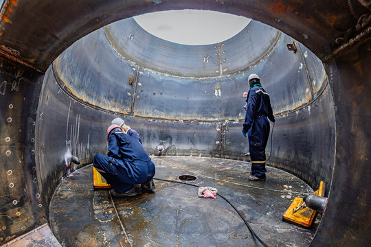 Male worker inspection vacuum test bottom plate tank petrochemical steel weld