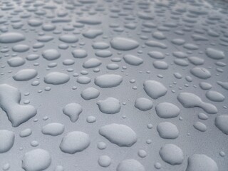 Close-up of Rain Water Droplets on Gray Hydrophobic Surface Texture