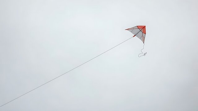 perigee. Broken kite string, kite drifting away in gray overcast sky, minimalist composition. wellbeing guides, coaching materials, designed for mental health education and mindfulness programs.