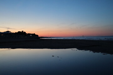 Sea sunset with shadow reflection in the river