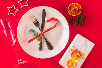 Christmas table setting for christmas dinner, served table with plate, gift, champagne glass, New...