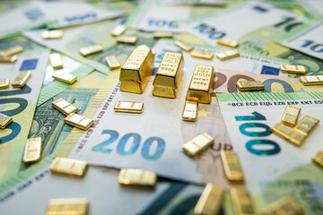 Gold bullion bars with euro cash, concept of rich lifestyle, financial independence and prosperity