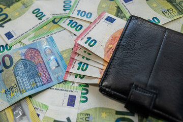 Euro banknotes with wallet background of modern finance