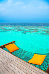 Tranquil closeup calm sea water waves with palm trees. Beautiful Panorama, Tropical island beach landscape exotic shore coast. Summer vacation, holiday amazing nature. Relax paradise, Maldives.