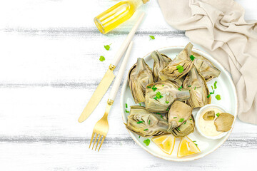 Traditional italian artichoke «alla romana», cooked carciofi vegetable. Olive oil, garlic, parsley