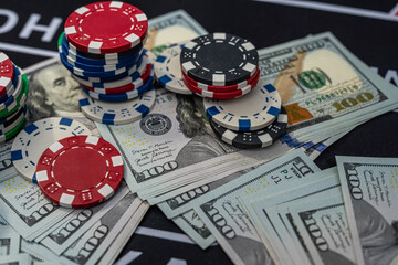 Stacks of colorful poker chips and US dollars showing casino wealth, risk, gambling and money winnings