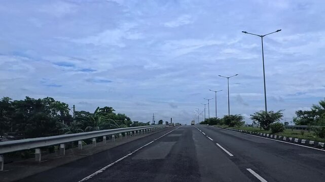 4k video clip of a road trip in a car as seen from driver point of view on a cloudy rainy day in India