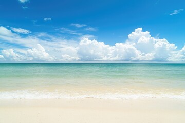 Obraz premium Tropical beach with calm turquoise water under a bright blue sky filled with fluffy white clouds, perfect for travel ads, holiday posters, and summer relaxation backgrounds