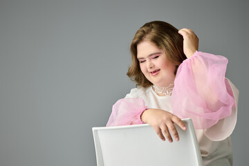 Young woman embraces joy with a radiant smile in soft pastel attire