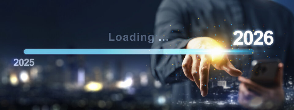 Business hand with a cellphone slides the loading bar from 2025 to 2026 on a virtual screen. Happy New Year concept or Celebration