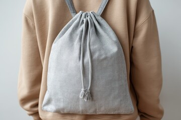 Drawstring Bag Mockup. Grey Material Template for Small Pursed Bag on Woman's Shoulder