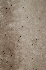 Rough concrete surface featuring numerous small holes