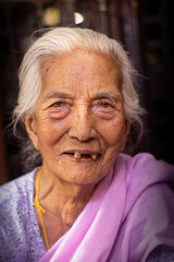 Nepali Elderly Woman with a Grateful Smile at Golden Temple, Lalitpur