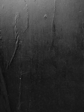 A vertical black poster with crease lines, a texture reminiscent of a wheatpaste street poster.