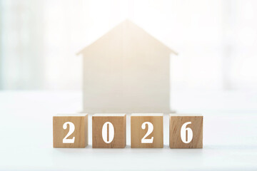 2026 on wooden blocks and sunlight house background. Home loan business concept.