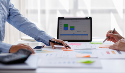 Team businesswoman hands using a calculator to check company finances and earnings and budget. Business woman calculating monthly expenses, managing budget, papers, loan documents, invoices
