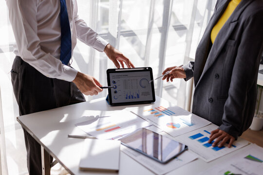 Financial Analysis. Business team woman calculating data with calculator and laptop in modern office.
