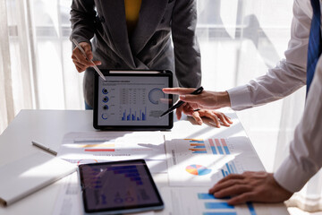 Financial Analysis. Business team woman calculating data with calculator and laptop in modern office.