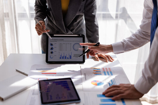 Financial Analysis. Business team woman calculating data with calculator and laptop in modern office.
