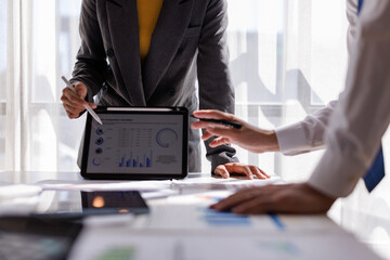 Financial Analysis. Business team woman calculating data with calculator and laptop in modern office.