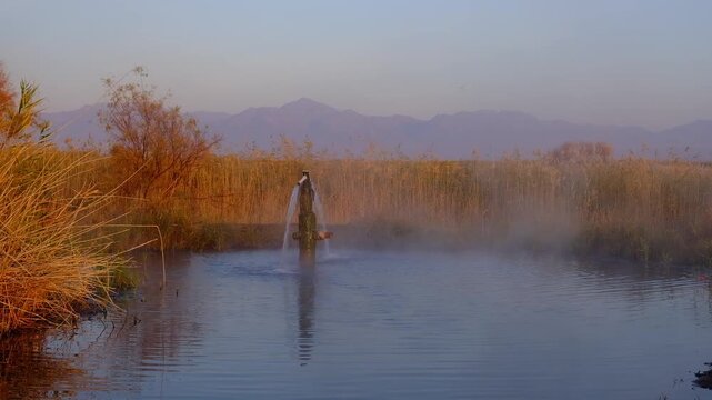 Ayak Kalkan thermal spring near the Ili River in Kazakhstan on a foggy autumn morning.