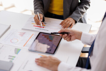 Team Business using calculator and laptop for do math finance on wooden desk in office and business working background, tax, accounting, statistics and analytic research concept
