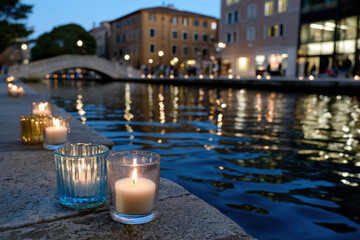 Fototapeta premium A picturesque canal adorned with glowing candles creates a romantic atmosphere, capturing the essence of evening strolls and serene moments by the water in urban settings.